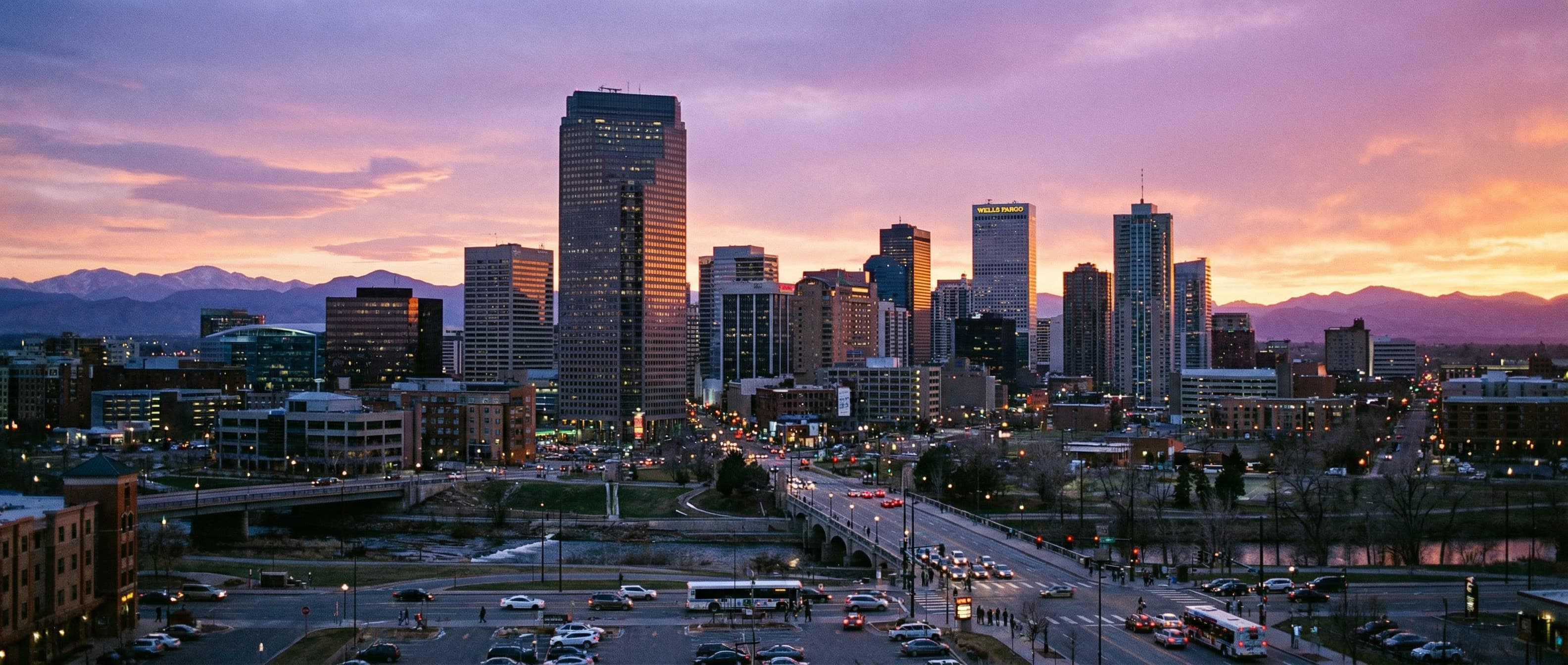 Denver skyline at dusk — party bus destination from Castle Rock